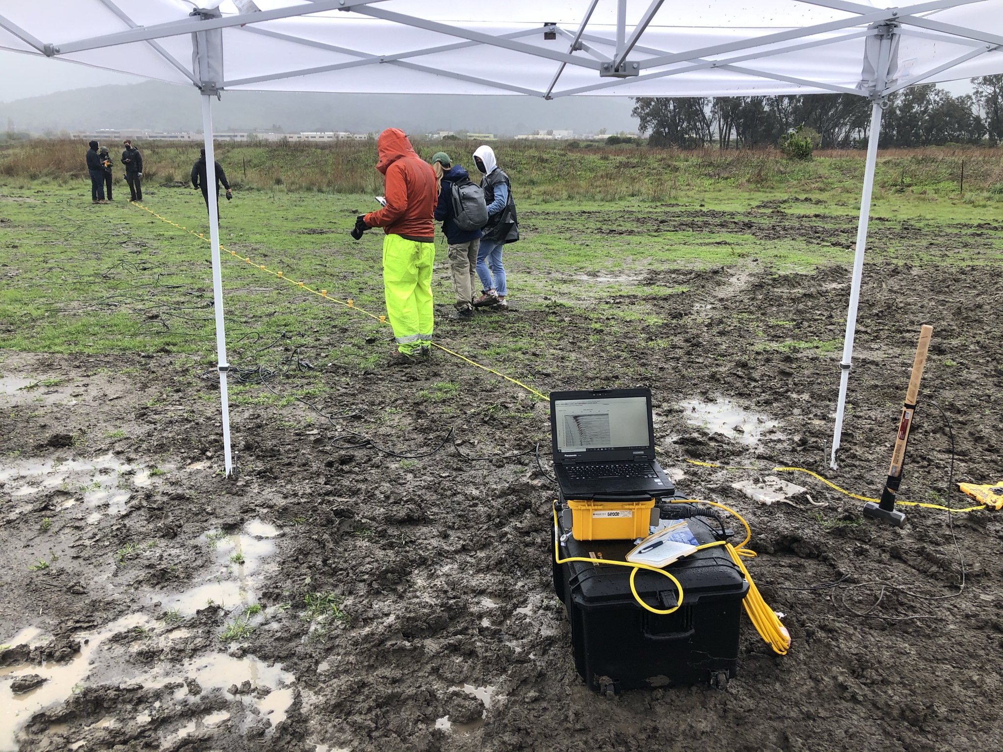 Students placing geophones to conduct shear wave velocity measurements